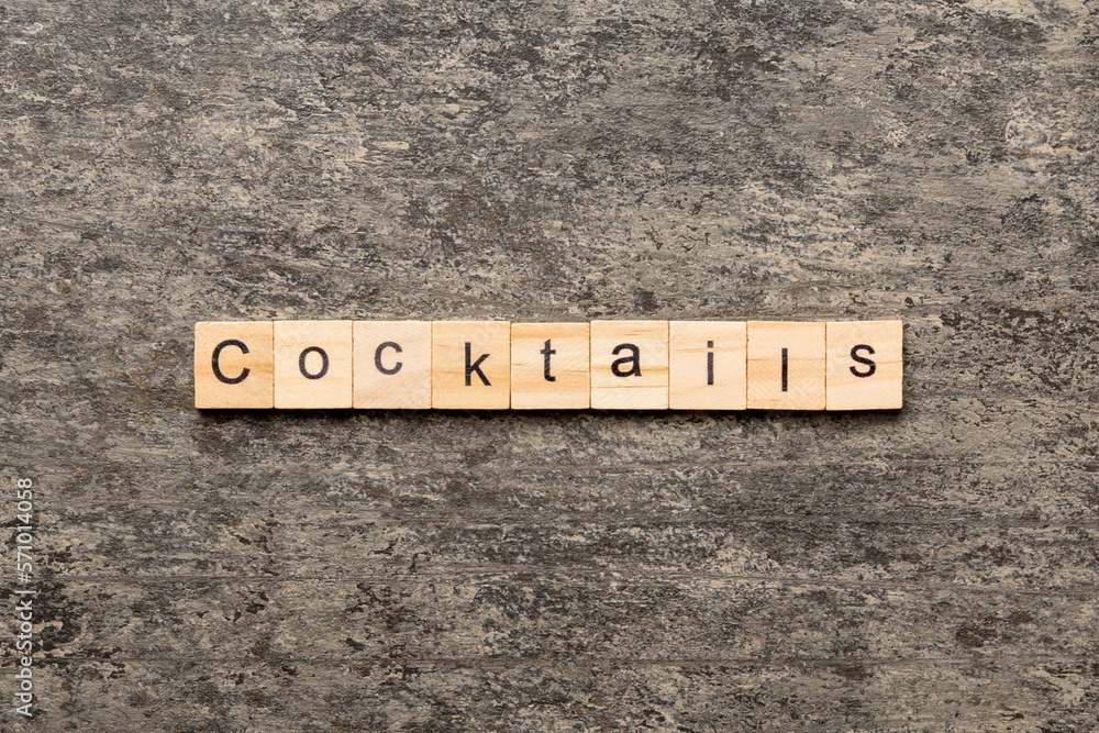 cocktails word written on wood block. cocktails text on cement table for your desing, concept cocktails word written on wood block. cocktails text on cement table for your desing, concept