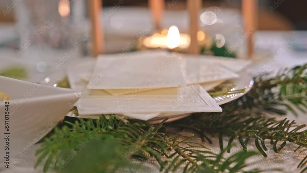 Traditional Polish Christmas Eve Dinner Table with White Christmas Wafer Laying on Hay Traditional Polish Christmas Eve Dinner Table with White Christmas Wafer Laying on Hay