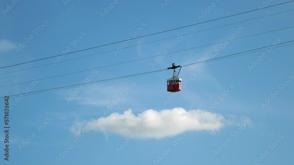 Cableway Teleferico del Puerto in Barcelona, Spain. Red Cable Cab Passes Station on sunny Day. Blue bright sky with clouds. Silhouette. High quality 4k footage Cableway Teleferico del Puerto in Barcelona, Spain. Red Cable Cab Passes Station on sunny Day. Blue bright sky with clouds. Silhouette. High quality 4k footage