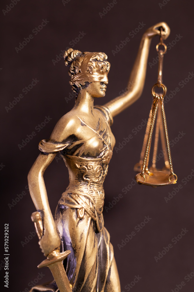 detail of lady justice statue on dark background