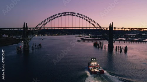 Drone Aerial Video Fishing Fleet Yaquina Bay Newport Oregon Coast Ships Marina Ships Coming and Going out to Sea 01 Slow forward push following fishing vessel entering Yaquina Bay, Newport, Oregon photo