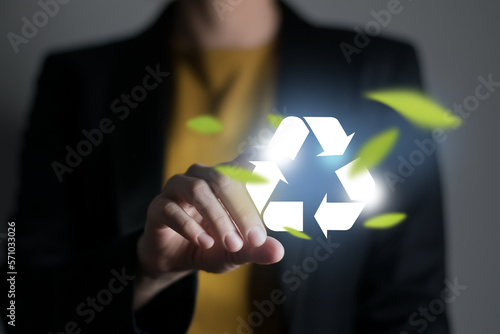 Woman pushing abstract recycle sign. Global ecological responsibility and clean future concept.