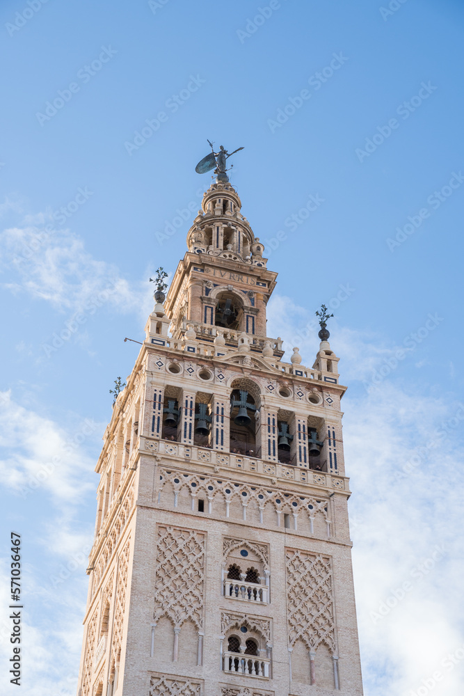The Giralda in Seville (Andalusia, Spain). The bell tower of Seville Cathedral. Views of the sculpture known as El Giraldillo.