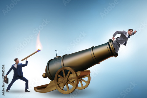 Valokuvatapetti Concept of lay-off with businessman and cannon