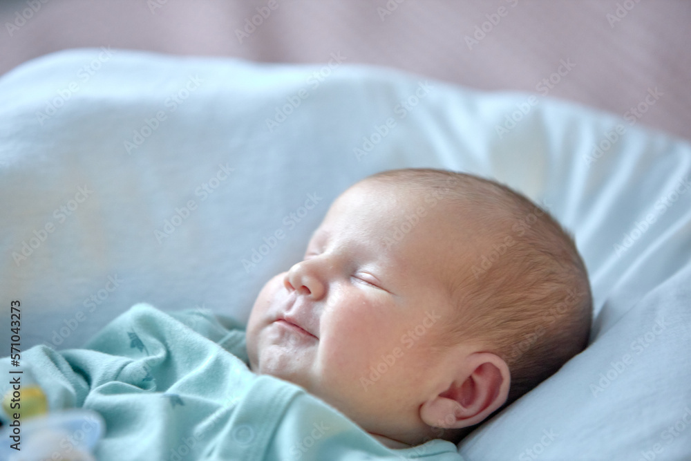 the newborn boy is sleeping. cute beautiful baby is sleeping closeup portrait of a beautiful sleeping baby on white. the newborn boy is sleeping. cute beautiful baby is sleeping closeup portrait of a beautiful sleeping baby on white.