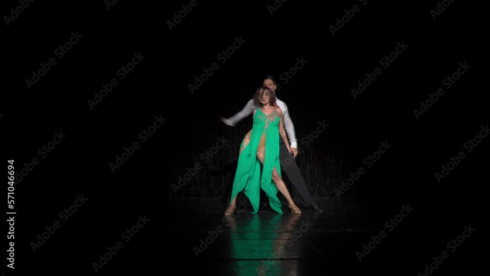 Concert combination based on rumba movements performed by dance pair demonstrating artistry and high technique of Latin dancing. Distant shot. Concert combination based on rumba movements performed by dance pair demonstrating artistry and high technique of Latin dancing. Distant shot.