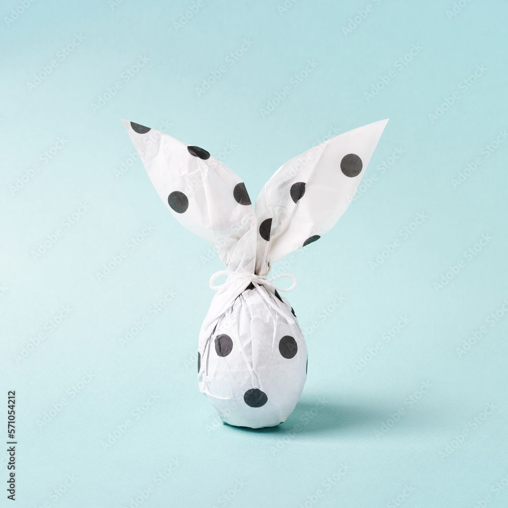 Easter bunny in wrapping paper, DIY gift concept, Easter egg as white  rabbit. Stock Photo by JuliaManga