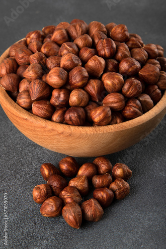 View of a bowl full of hazelnuts on a black background