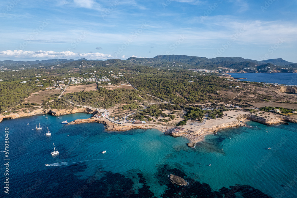 Obraz premium Aerial photographs of the beaches of Cala Conta and Cala Escondida, on the island of Ibiza during a sunny summer day with blue sky and turquoise water