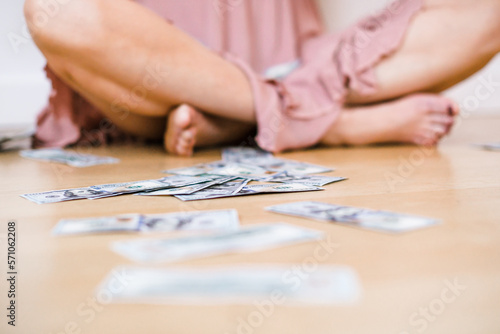 money on floor close up white woman
