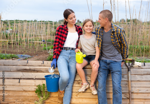 Portrait of friendly family in the backyard of a cottage photo