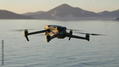 Montenegro, january 2023: drone dji mavic 3 fly, hover over the sea at sunset. back side of drone