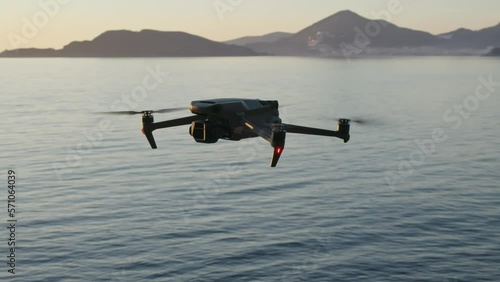 Montenegro, january 2023: drone with a camera dji mavic 3 fly over the sea at sunset photo