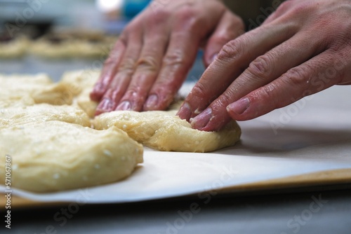 baker at work. The baker shapes the bread. Hands on the close-up form bread