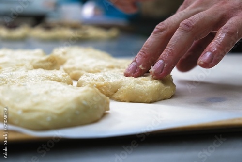 baker at work. The baker shapes the bread. Hands on the close-up form bread