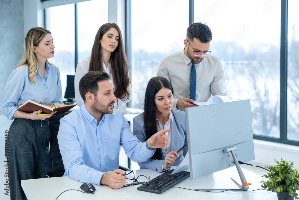 Group of business people looking at computer screen and getting upset because of failure in the office