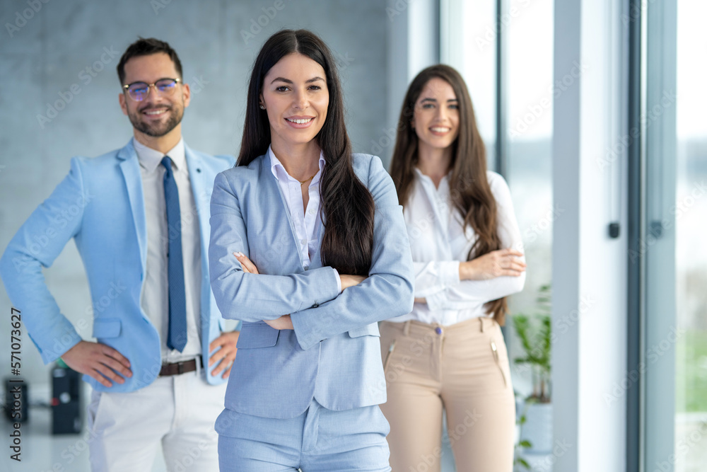 Portrait of confidence business professionals standing with arms crossed at office. Portrait of confidence business professionals standing with arms crossed at office.