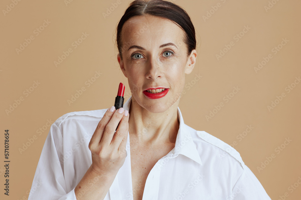 modern 40 years old woman in white shirt isolated on beige modern 40 years old woman in white shirt isolated on beige