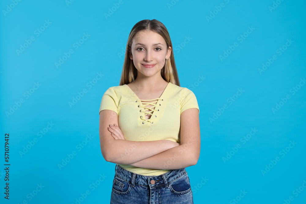 Portrait of beautiful teenage girl on light blue background Portrait of beautiful teenage girl on light blue background