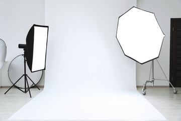 Interior of modern photo studio with professional lighting equipment