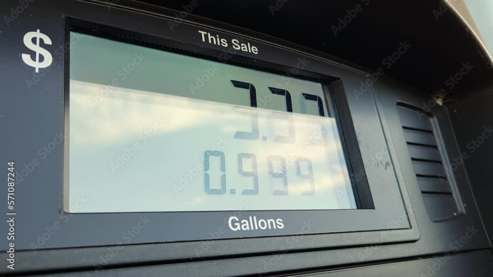 Close up of a gasoline pump at gas station showing dollars payed for gallons of fuel pumped. Screen showing total cost for filling up a car tank. High gas prices Close up of a gasoline pump at gas station showing dollars payed for gallons of fuel pumped. Screen showing total cost for filling up a car tank. High gas prices