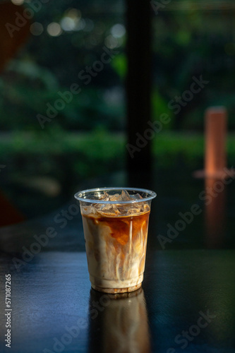 Iced Latte Coffee in a Plastic Glass on a Black Table at a Coffee shop