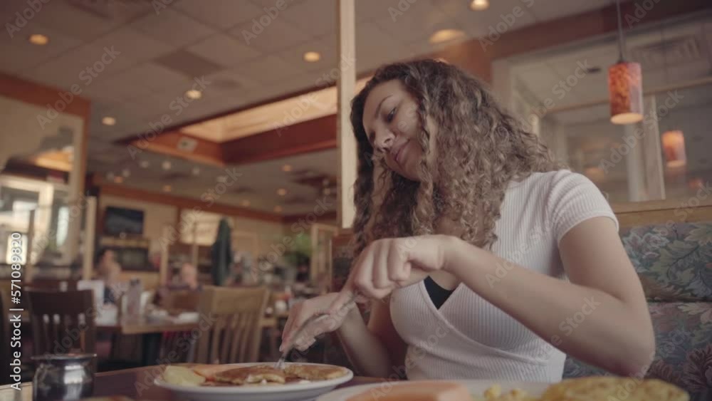 Girl in a restaurant talking on the phone Girl in a restaurant talking on the phone