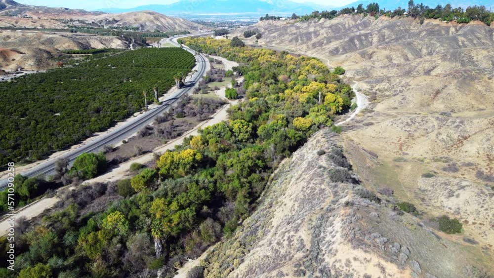 A UAV Drone Aerial view of the San Timoteo Canyon over a Hiking Trail in Redlands, California A UAV Drone Aerial view of the San Timoteo Canyon over a Hiking Trail in Redlands, California