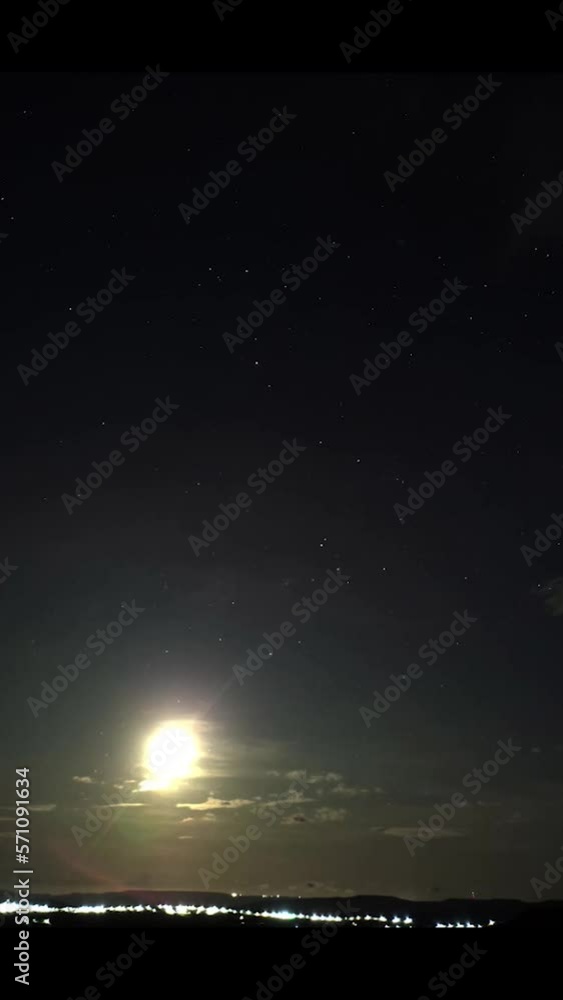 time-lapse of the moon rising with stars the stars around it in the sky with clouds time-lapse of the moon rising with stars the stars around it in the sky with clouds