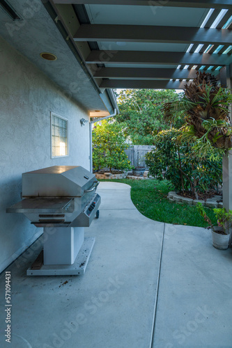 Backyard patio with barbecue grill.