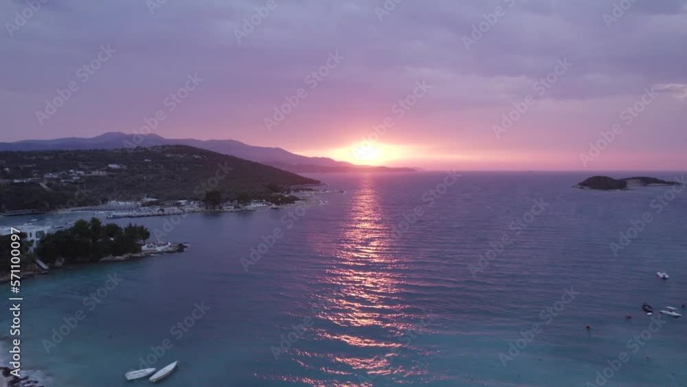 Aerial of Soothing Sunset into Ionian Sea shrouds Ksamil shore, Albania Aerial of Soothing Sunset into Ionian Sea shrouds Ksamil shore, Albania