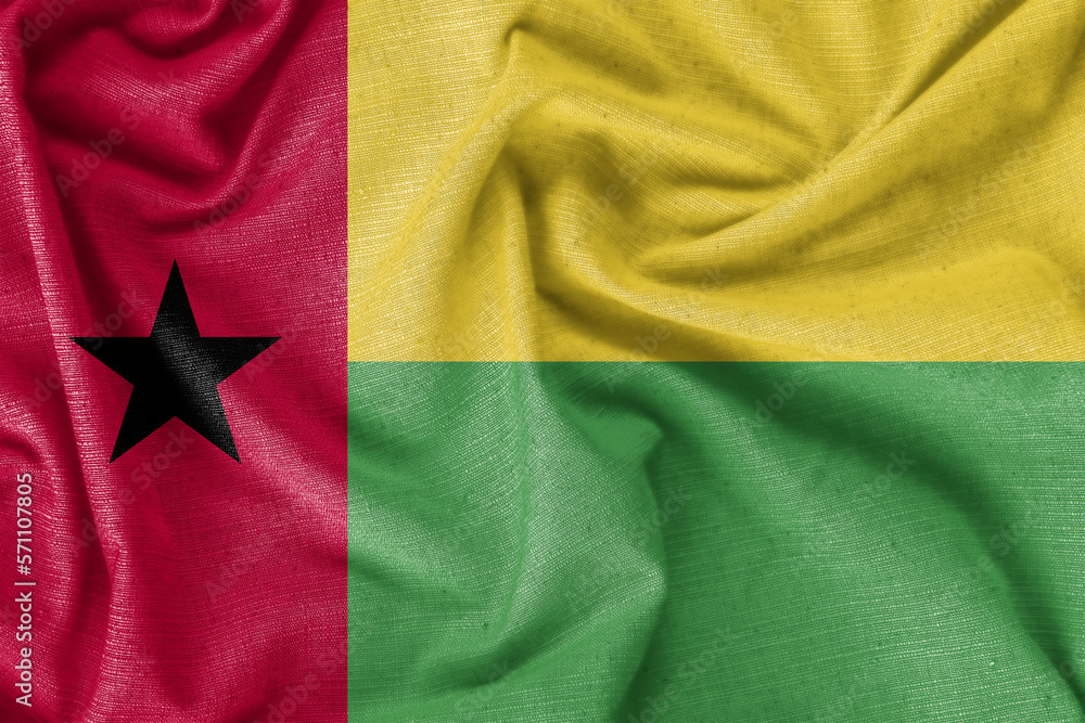 Fototapeta premium Guinea-Bissau country flag background realistic silk fabric