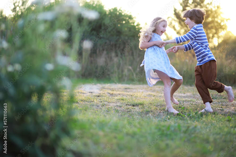 Fototapeta premium Children walk in the summer in nature. Child on a sunny spring morning in the park. Traveling with children.