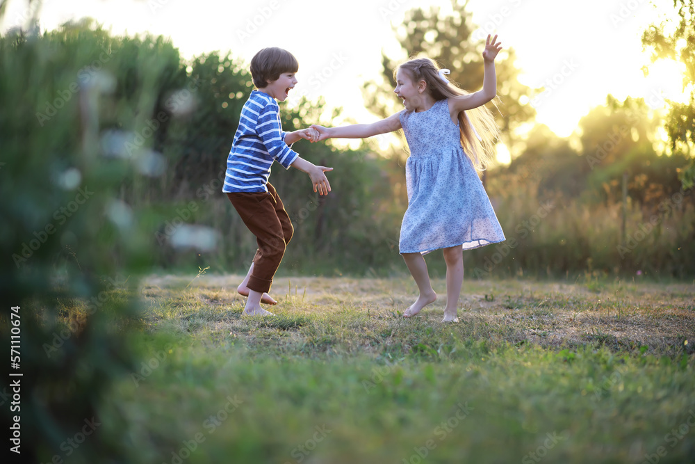 Fototapeta premium Children walk in the summer in nature. Child on a sunny spring morning in the park. Traveling with children.