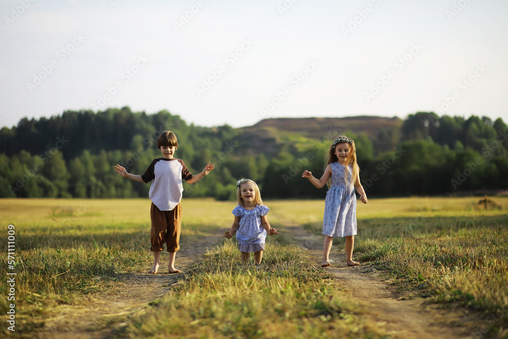 Children walk in the summer in nature. Child on a sunny spring morning in the park. Traveling with children.