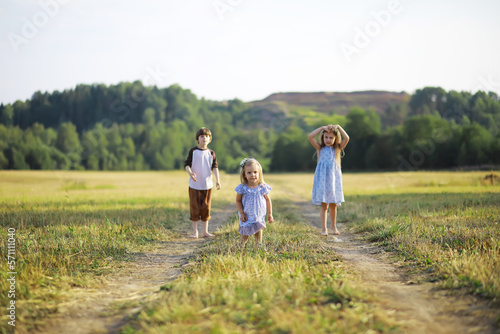 Children walk in the summer in nature. Child on a sunny spring morning in the park. Traveling with children.