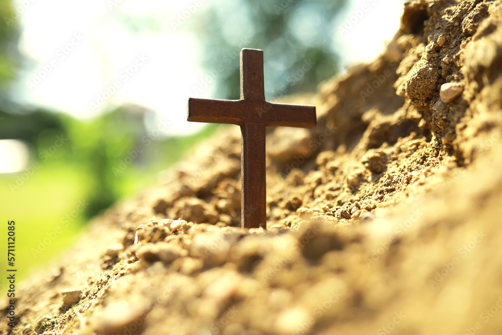 Concept conceptual black cross religion symbol silhouette in grass