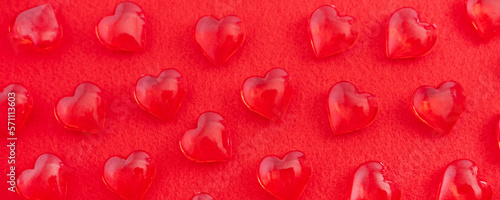 Valentines Day background February 14th. Confetti, red hearts on red background. banner