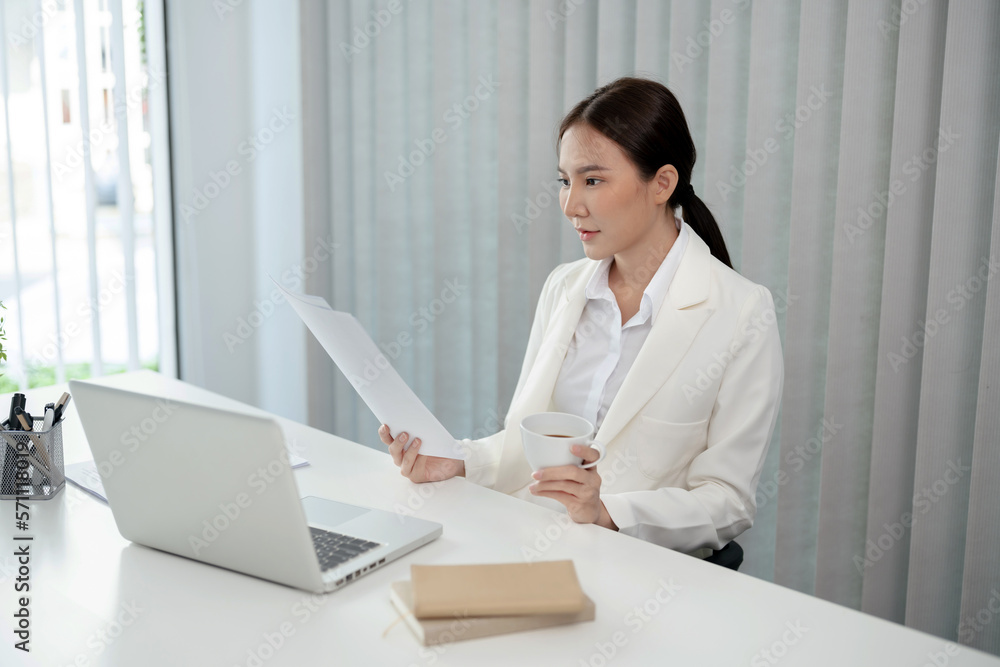 Asian businesswoman working on laptop and mobile phone Start up small business owner. business successful technology concept Asian businesswoman working on laptop and mobile phone Start up small business owner. business successful technology concept
