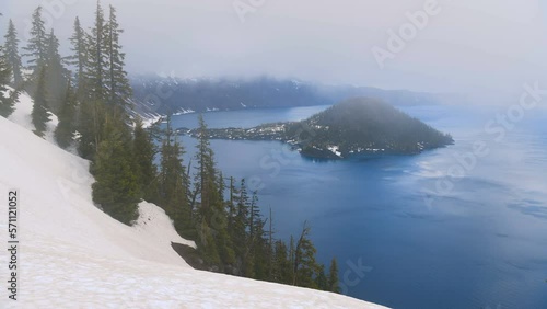 Spring at Crater Lake - A time-lapse video of low clouds flying over blue Crater Lake and rocky Wizard Island on a stormy Spring evening. Crater Lake National Park, Oregon, USA. photo