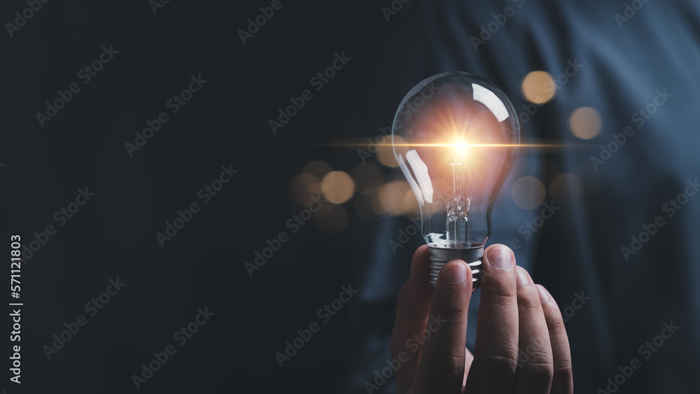 businessman hold light bulb inspired by innovative business idea, male boss or director motivated with successful startup in office, innovation, energy save concept. - obrazy, fototapety, plakaty 