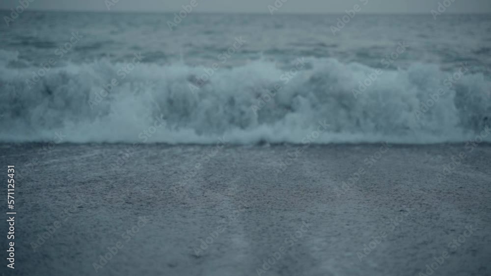 Wave hitting beach in slow motion Wave hitting beach in slow motion