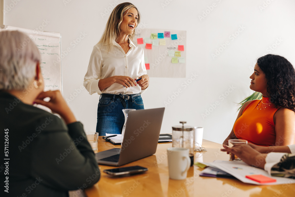 Happy businesswoman having a meeting with her team Happy businesswoman having a meeting with her team