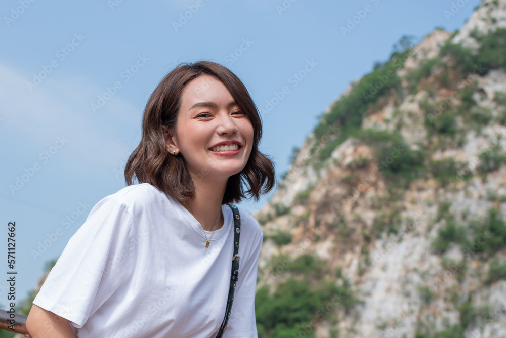 Woman smiling with perfect smile and white teeth in a park and looking at camera, Portrait of beautiful woman smiling and looking away at park during sunset. Happy cheerful girl laughing at park.