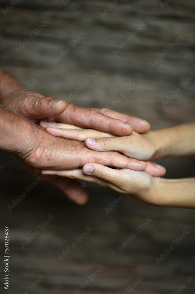 man holding granddaughter's hand on a blurry background