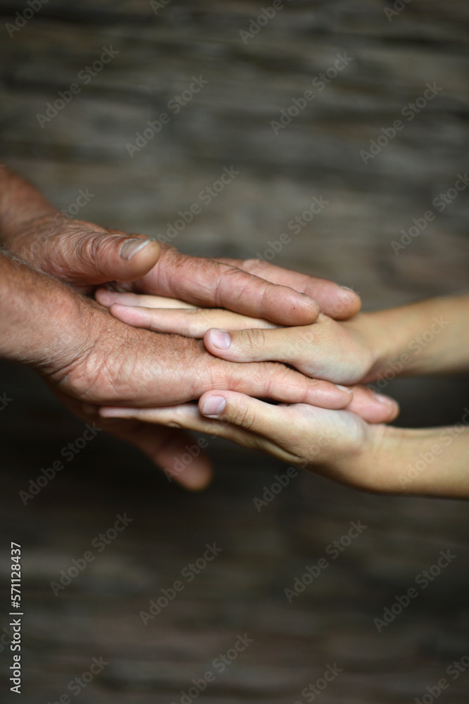 man holding granddaughter's hand on a blurry background man holding granddaughter's hand on a blurry background