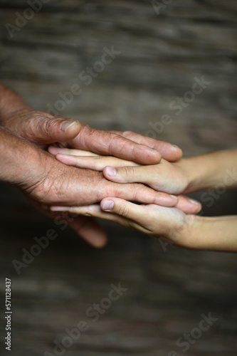 man holding granddaughter's hand on a blurry background © aletia2011