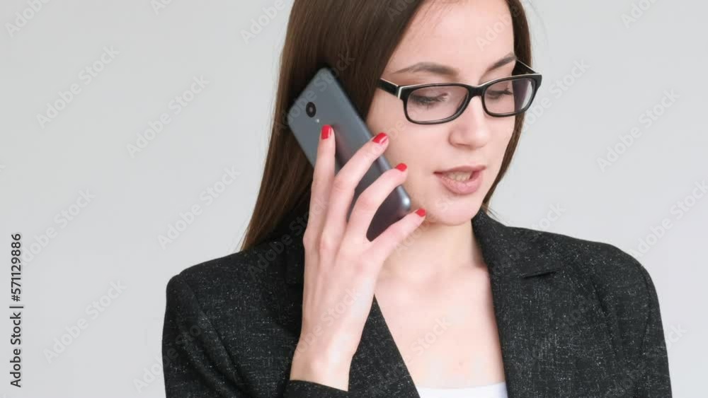 Bank call. Data verification. Confident business woman in glasses black blazer using mobile phone credit card isolated on gray copy space background. Customer support. Cashless payment. Bank call. Data verification. Confident business woman in glasses black blazer using mobile phone credit card isolated on gray copy space background. Customer support. Cashless payment.