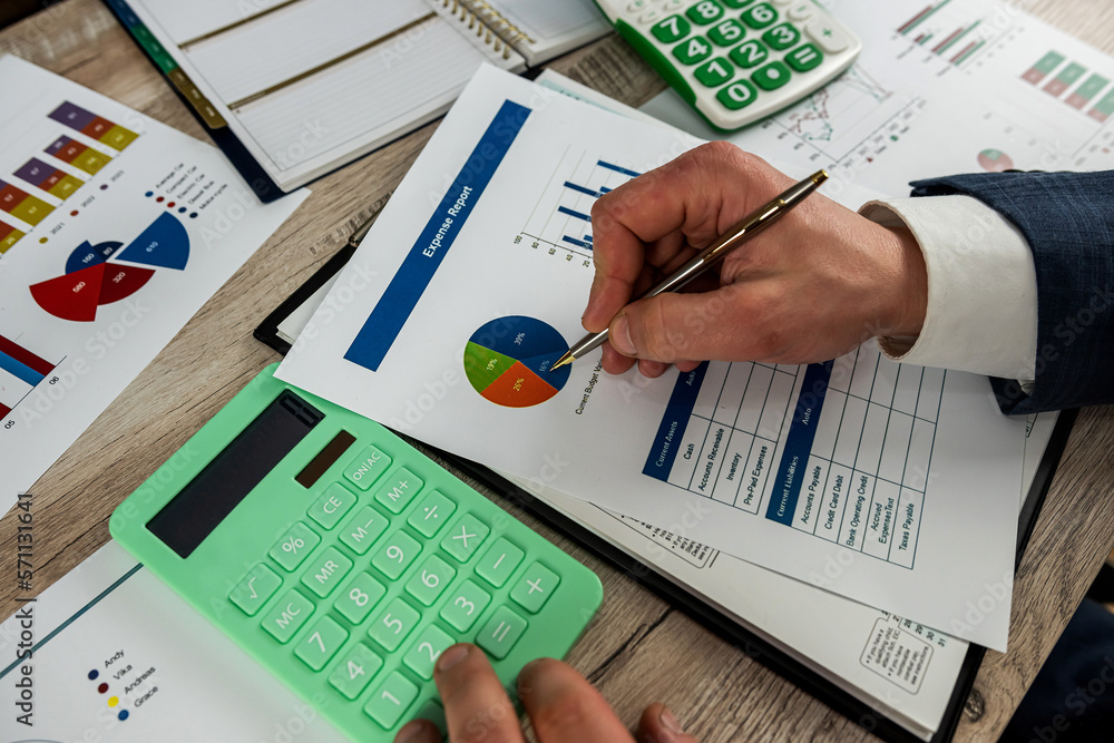 Business man using calculator for accounting finance chart and diagram Business man using calculator for accounting finance chart and diagram