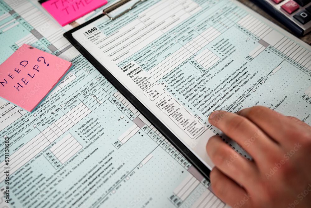 Man work with 1040 blank individual income tax return form Man work with 1040 blank individual income tax return form